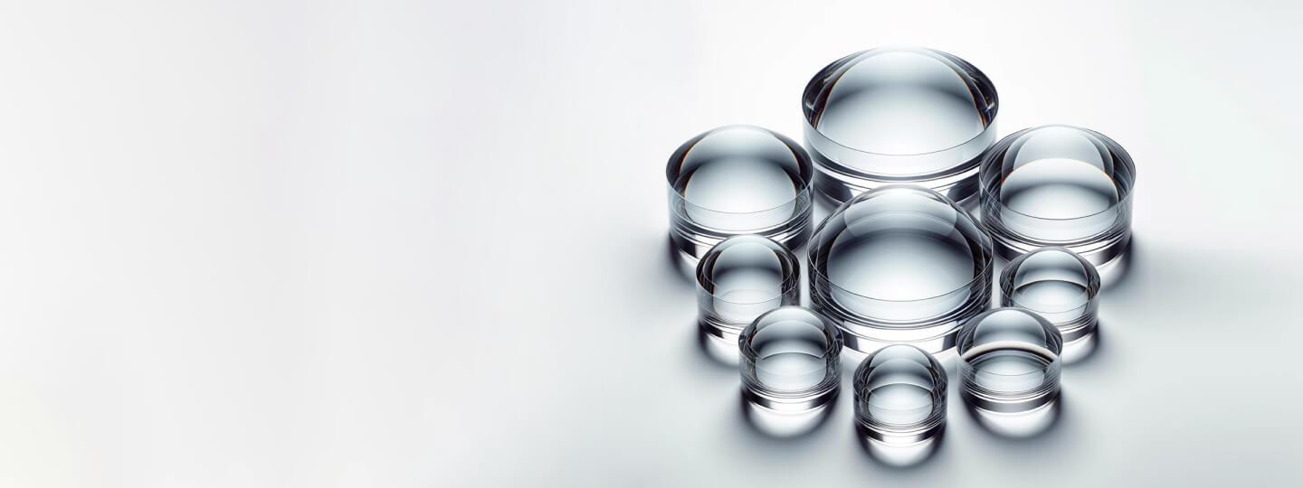 Various sizes and radius lenses - convex, concave, meniscus, spherical, cylindrical, aspherical, placed next to each other.